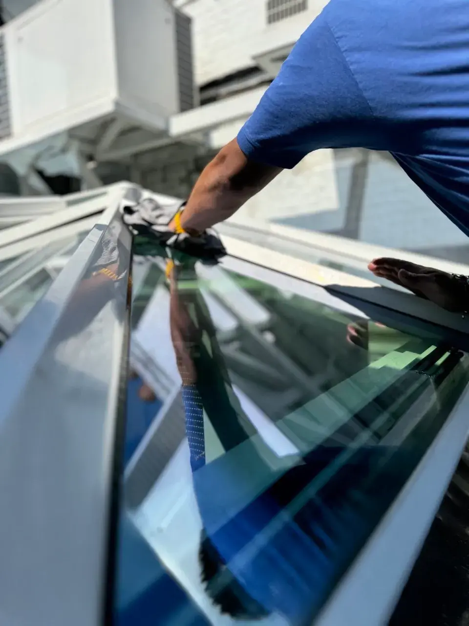 Hand finishing a skylight after a soft wash