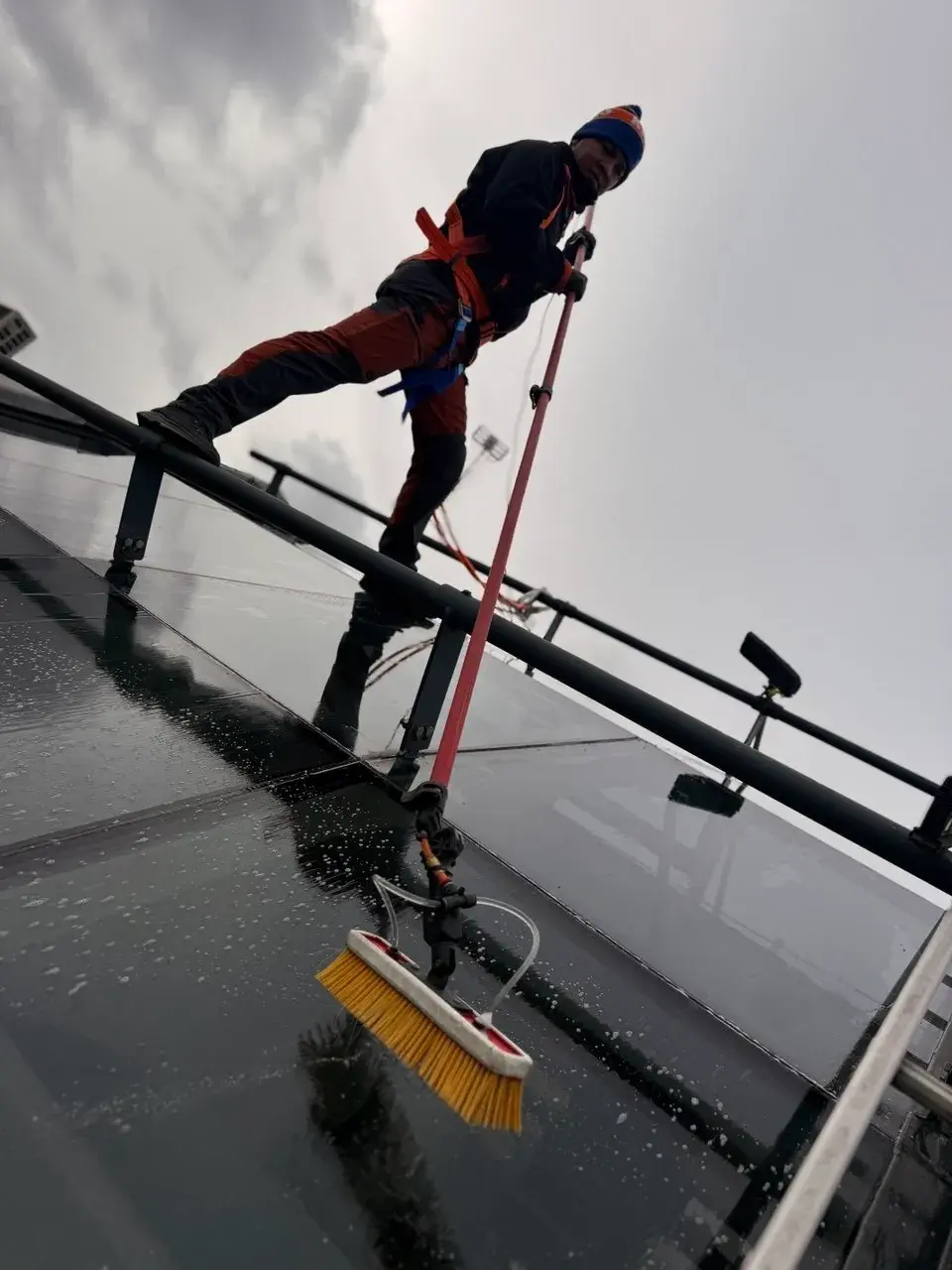 WrXperts team member cleaning a skylight