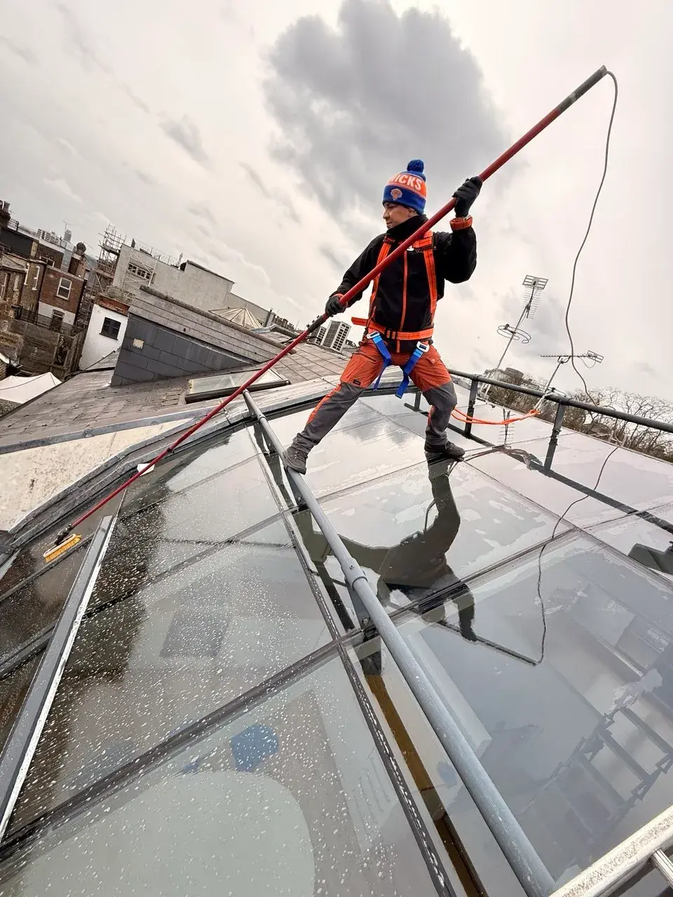 View from below of a roof clean in progress