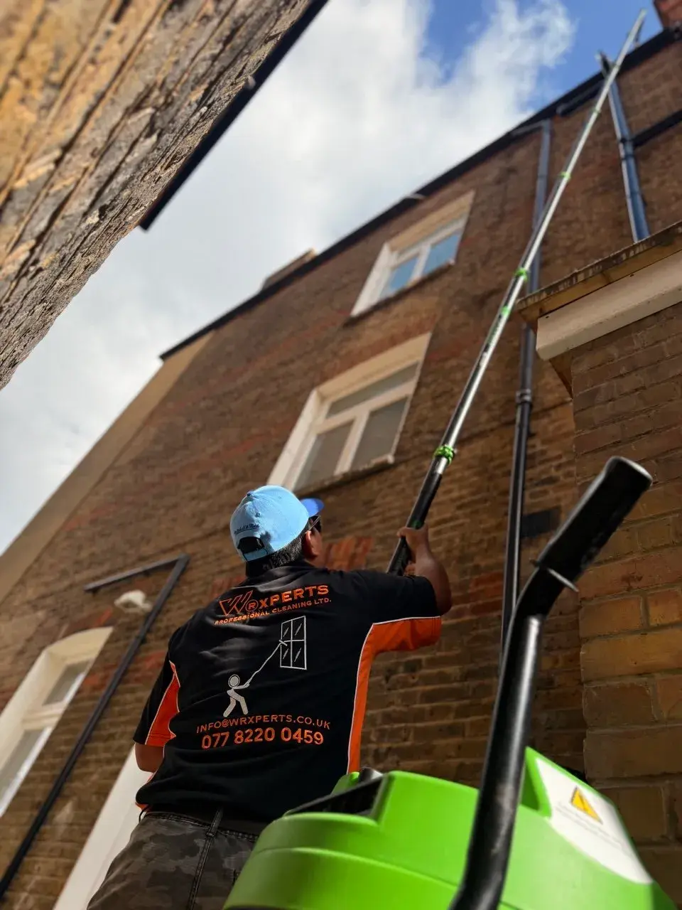 WrXperts window cleaner in branded uniform