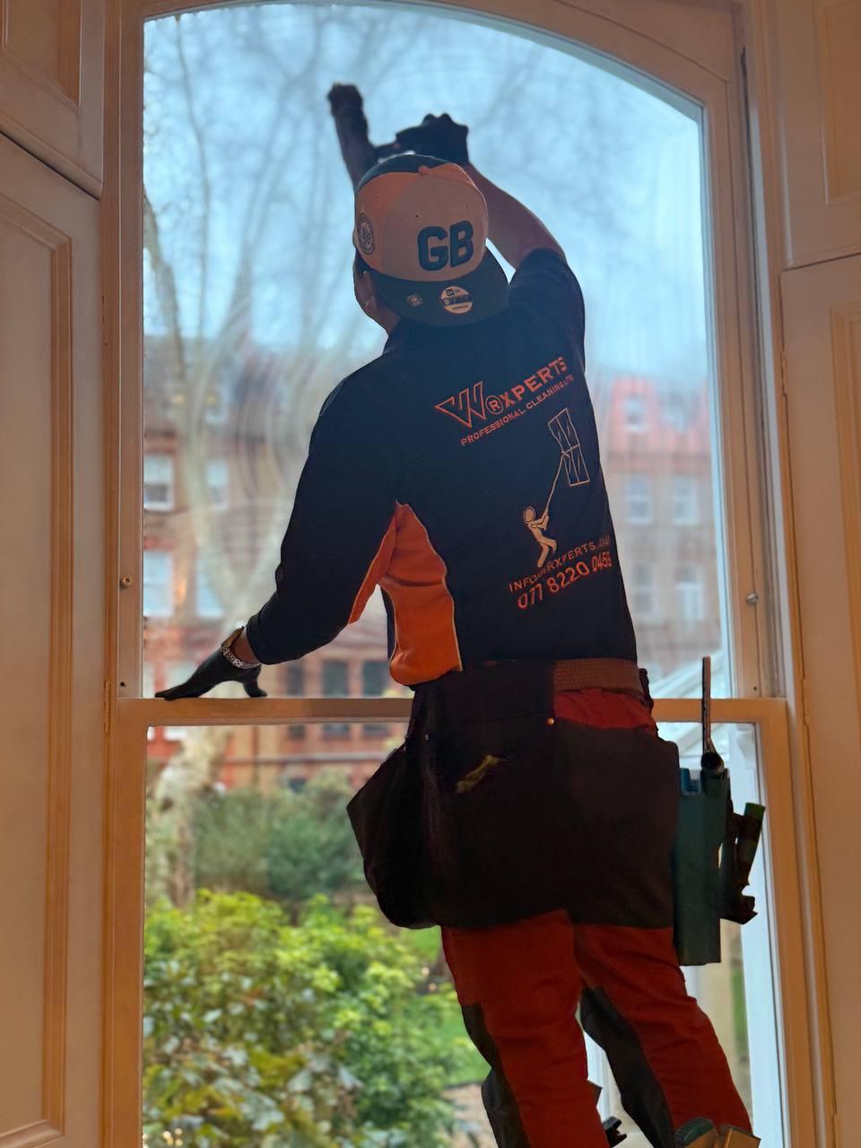 Window cleaner working on a Victorian London house