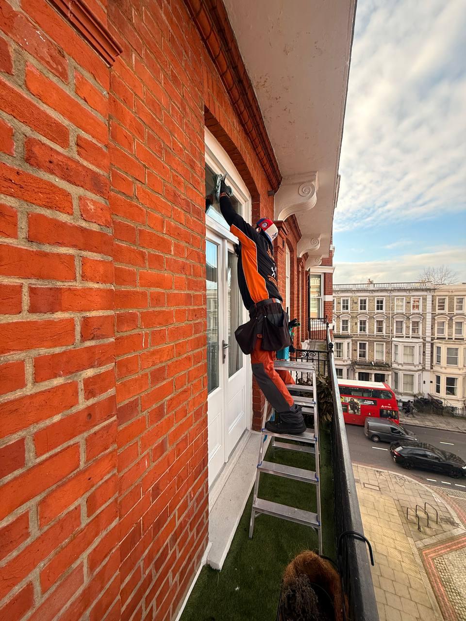 Window cleaner working on a Victorian London house