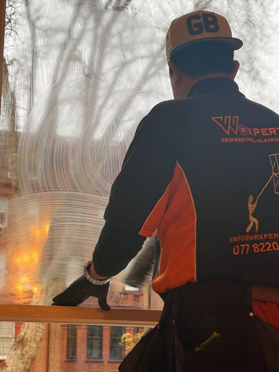 Window cleaner working on a Victorian London house