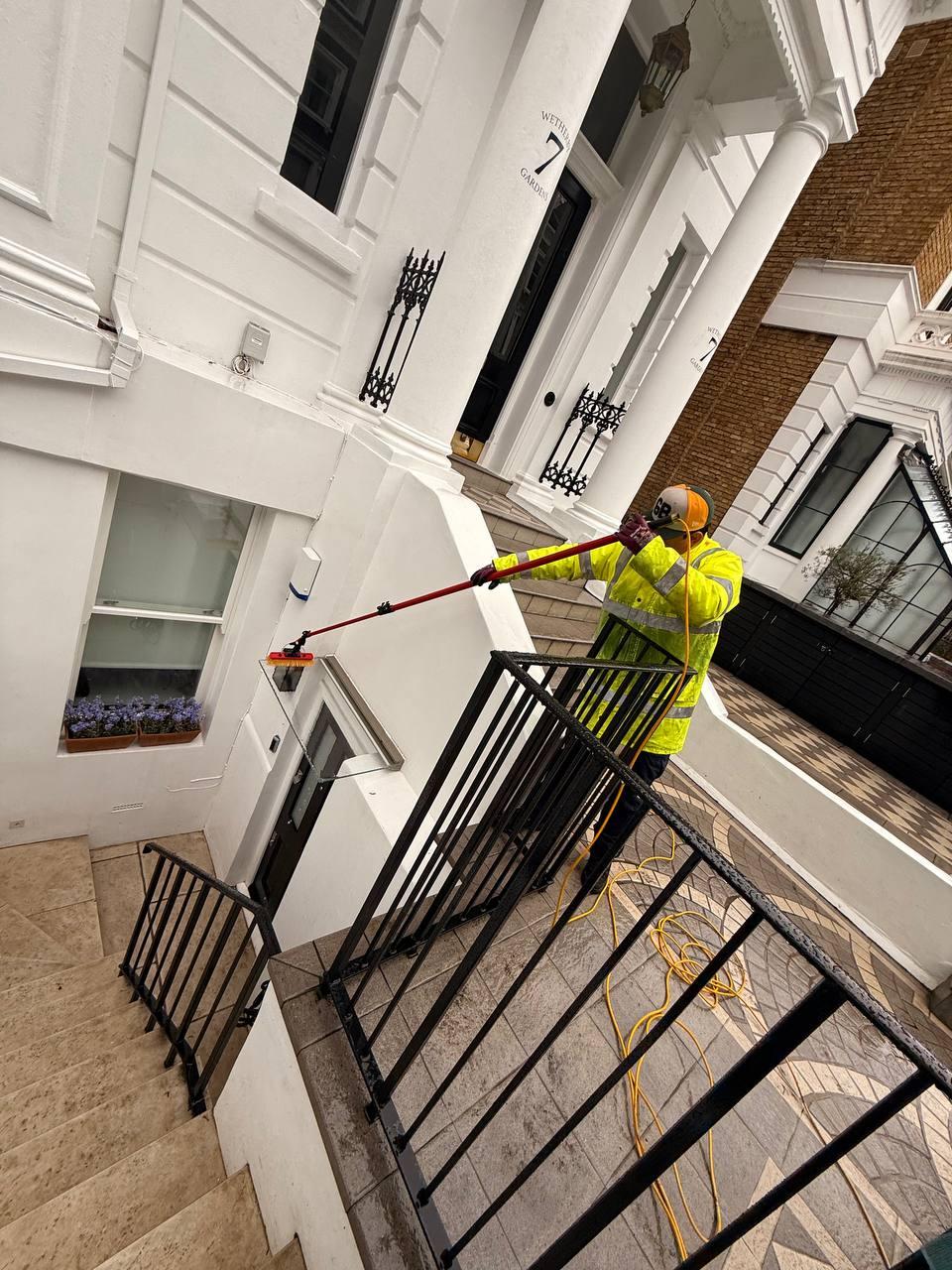 Window cleaner working on a Victorian London house