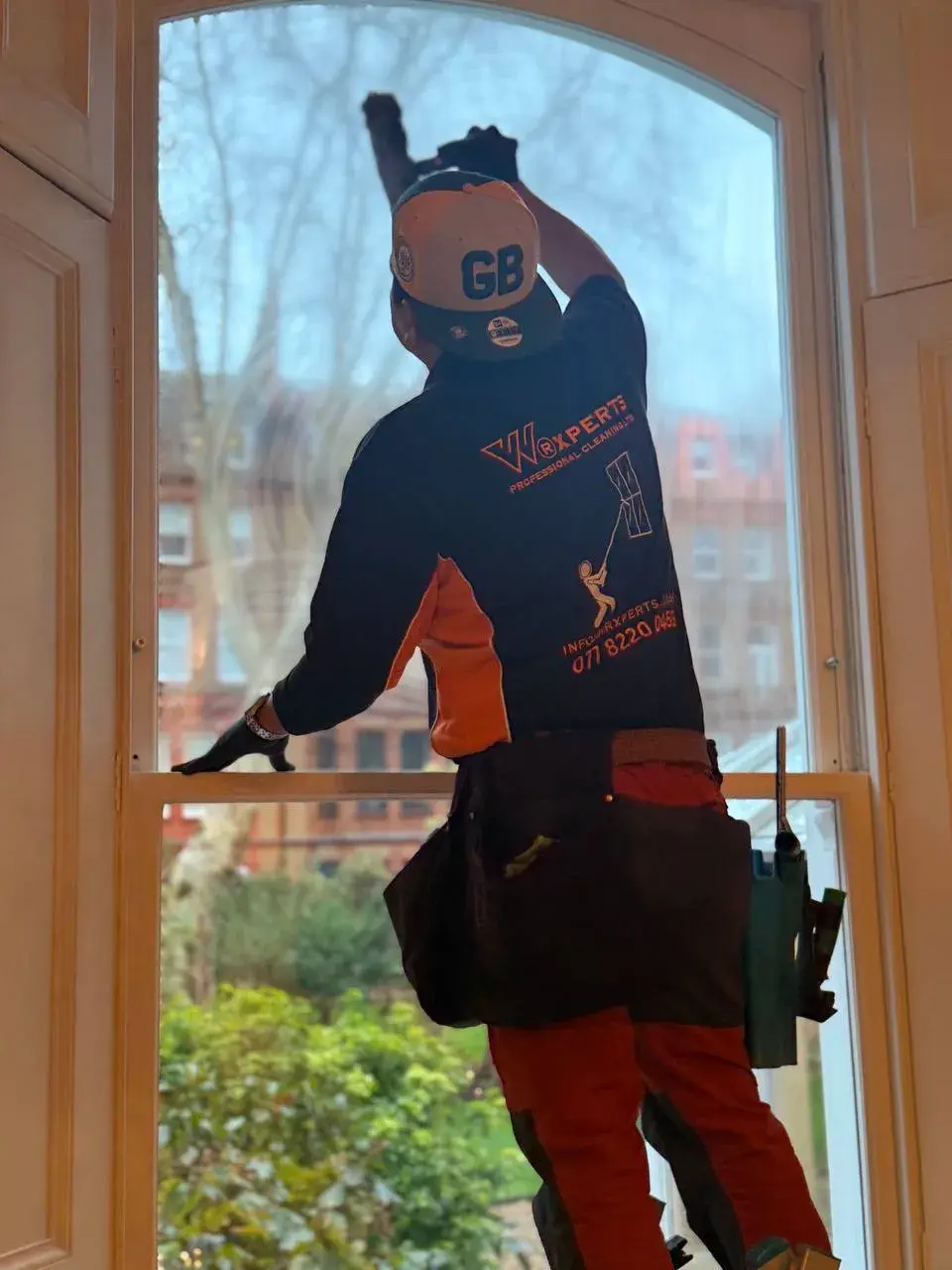 Window cleaner working on a Victorian London house